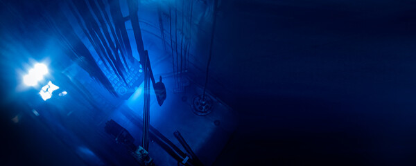 Banner Blue glow water of nuclear reactor core powered, caused by Cherenkov radiation, fuel plates...