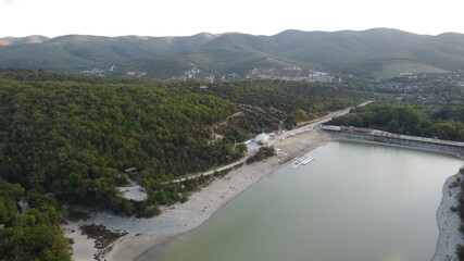 turquoise lake from the air with mountains in the background