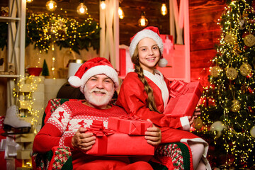 Obraz na płótnie Canvas Expressing their love. happy new year. father and daughter love christmas. xmas happiness and joy. Present for kid. grandpa and grandchild at home. family holiday weekend. Little girl with santa man