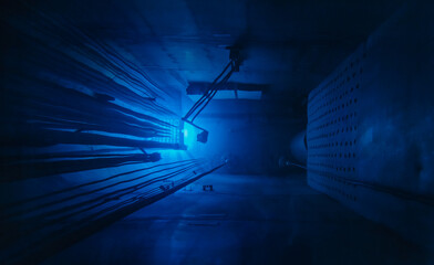 Blue glow water of nuclear reactor core powered, caused by Cherenkov radiation, fuel plates...