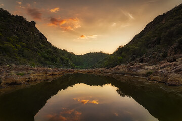 river between hills at sunset