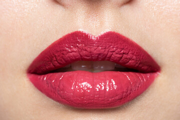 Close up of woman's natural lips with bright fashion pink glossy makeup. Macro photography of...