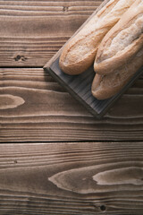 Fresh french baguette on wooden board. ready to eat