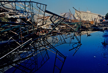 Water pooled and reflecting collapsed buildings from evening firefight in Marina District, San Francisco, California after the Loma Prieta 1989 Earthquake.