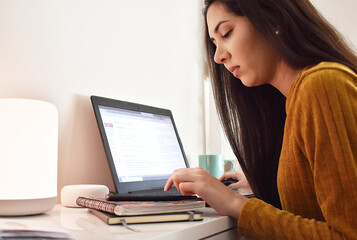 Girl working in home office with her laptop and smartphone in quarantine for covid19