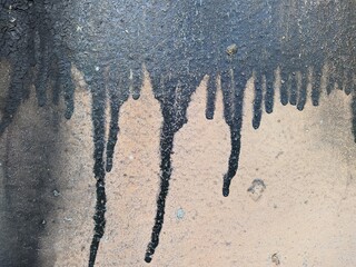 black flowing paint on a bright background photo