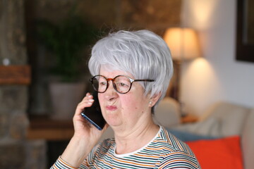 Distraught senior woman calling from home