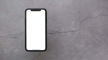Phone on gray background with white screen for copy-space.