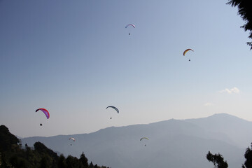 Fototapeta na wymiar Paragliding is the recreational and competitive adventure sport of flying paragliders