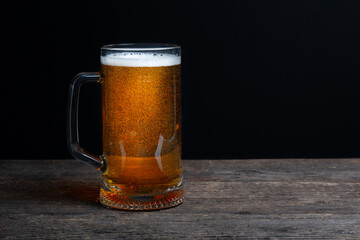 Glass of beer on a black background. Beer with copy space.