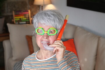 Senior woman snorkeling in the sofa