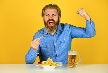 Friday party concept. Good appetite. Consume alcohol. Enjoy your meal. Beer and food. Dinner at pub. Hungry man drink beer and eat snacks. Bar restaurant. Cheerful man bearded hipster drinking beer - obrazy, fototapety, plakaty