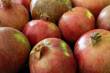Pomegranate natural background with close up on a ripe granates ready for juice press.