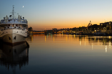 Szczecin. After dusk. View of the river and ships and the historic part of the city, Poland