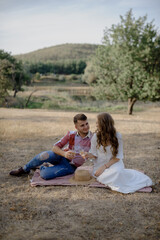 Couple spending time in a park, outdoors at a picnic.