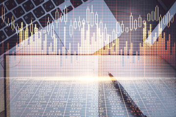 Stock market graph and top view computer on the table background. Multi exposure. Concept of financial education.