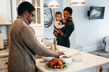 Black father preparing meal for thanksgiving family dinner