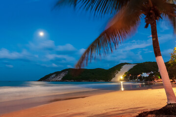 Ponta Negra beach, with Morro do Careca in the background, on a full moon night, Natal, Rio Grande...