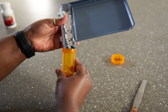 Black pharmacist prepare medication for hospital patient