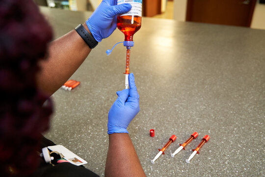 Black pharmacist prepare medication for hospital patient