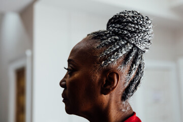 Profile of Senior Black woman with grey hair and braids