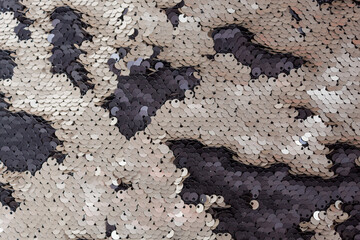 background of black and beige sequins. textured background. sequin fabric
