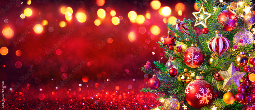 Wall mural abstract christmas tree with defocused lights on red glitter background