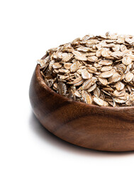 Wooden bowl with rye flakes isolated on white