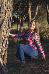 smiling young woman in plaid shirt in the field