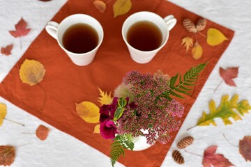 Warm fall beverage of hot tea with autumn leaves decor to sip and enjoy on cool seasonal days...