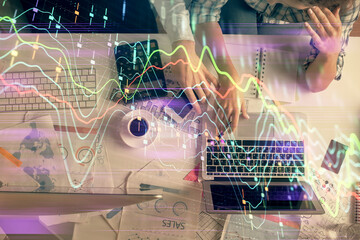 Double exposure of man and woman working together and financial graph hologram drawing. market analysis concept. Computer background. Top View.