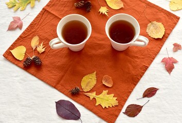 Warm fall beverage of hot tea with autumn leaves decor to sip and enjoy on cool seasonal days...