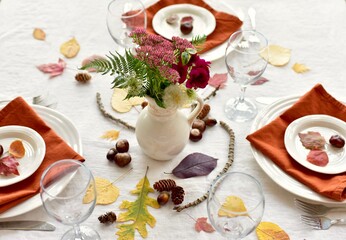 Obraz na płótnie Canvas Festive fall natural decorative elements arranged for elegant beautiful autumn table centrepiece for family Thanksgiving dinner celebration
