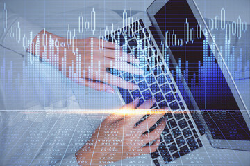 Double exposure of woman hands working on computer and forex chart hologram drawing. Top View. Financial analysis concept.