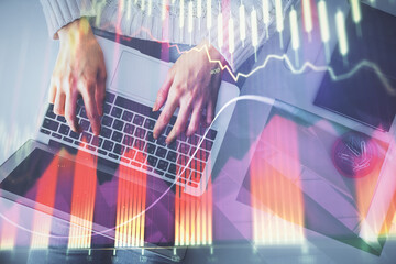 Multi exposure of woman hands working on computer and forex chart hologram drawing. Top View. Financial analysis concept.