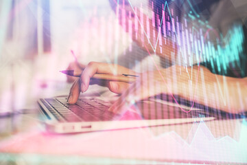 Multi exposure of woman hands typing on computer and financial graph hologram drawing. Stock market analysis concept.