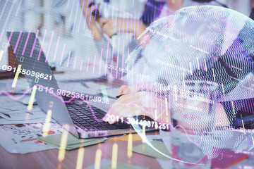 Multi exposure of woman hands typing on computer and forex chart hologram drawing. Stock market...