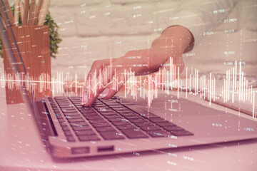 Multi exposure of woman hands typing on computer and forex chart hologram drawing. Stock market analysis concept.