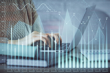 Double exposure of woman hands typing on computer and forex chart hologram drawing. Stock market analysis concept.