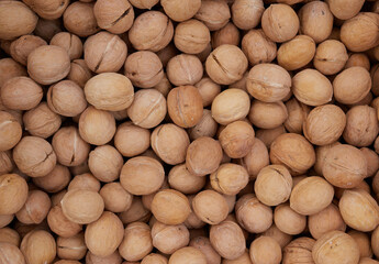 Top view of walnuts in nutshells in full screen