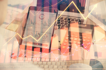 Double exposure of man's hands holding and using a digital device and forex graph drawing. Financial market concept.