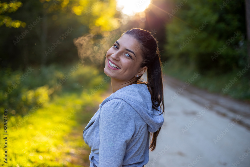 Wall mural portrait of a smiling woman in a park.