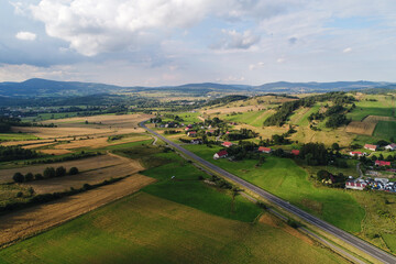Hills and mountains among meadows. The meadows crossed by lines of trees constitute the landscape of the vicinity of Kamienna Góra in Poland © Ungrim