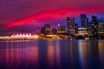 Naklejka na ściany i meble View of Coal Harbour in Downtown Vancouver, British Columbia, Canada, after Sunset. Modern City Skyline during Night. Dramatic Sky Artistic Render
