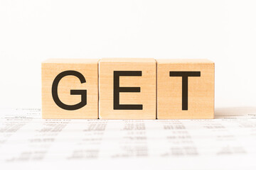 Word get. Wooden small cubes with letters isolated on white background with copy space available