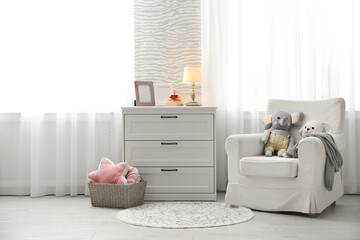 Fototapeta na wymiar Comfortable armchair in modern baby room interior