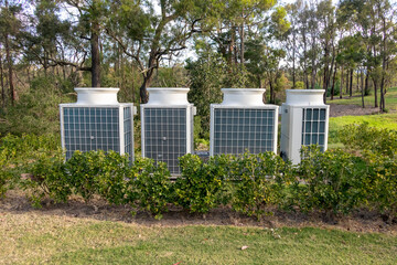 Fototapeta na wymiar Air conditioner cooling towers outside in a garden