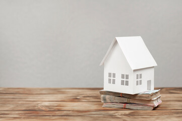Obraz na płótnie Canvas Miniature house. Stack or money. Home buying concept.