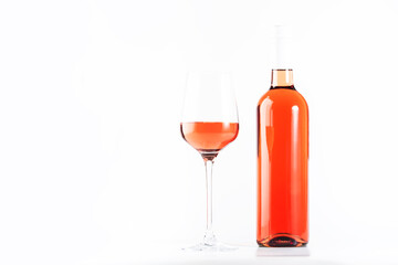Rose wine glass with bottle on the white table. Rosado, rosato or blush wine tasting in wineshop, bar concept. Copy Space