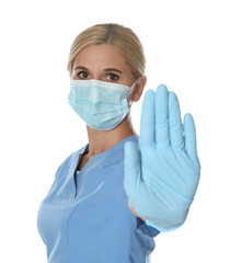 Doctor in protective mask showing stop gesture on white background. Prevent spreading of coronavirus